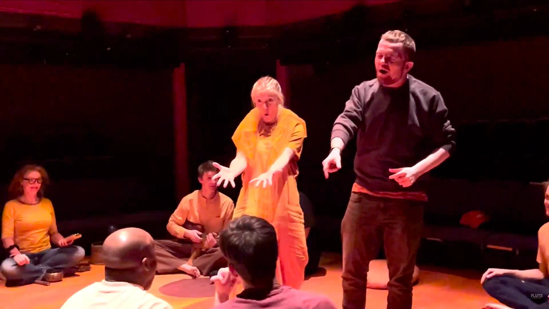 Flute Theatre actors perform an interactive moment from Twelfth Night, using expressive gestures and rhythm to engage autistic participants seated in a circle through the Hunter Heartbeat Method.
