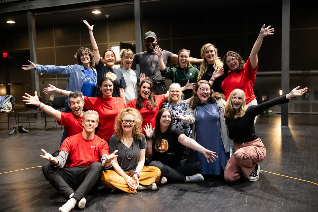 Group photo of Flute Theatre company and audience members in Ohio at OSU Wexner Center for the Arts celebrating the Shakespeare and Autism program with joyful open arms.