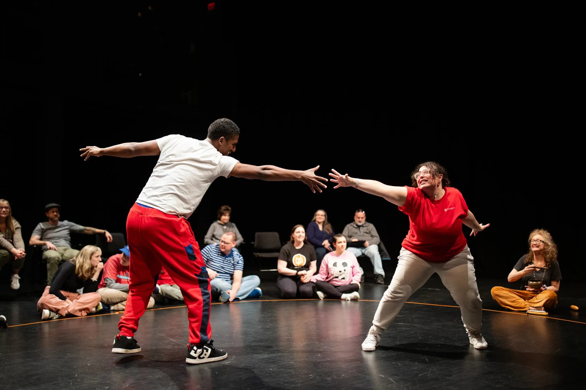 Flute Theatre performers and participants in Ohio at OSU Wexner Center for the Arts during the Shakespeare and Autism program in 2025, reaching out dramatically in a sensory-friendly interactive performance.