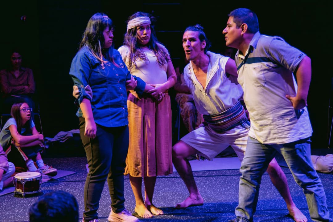 Four actors in an intense dramatic moment during a performanceof La Tempestad at Teatro La Plaza in Peru, with an engaged audience watching closely.