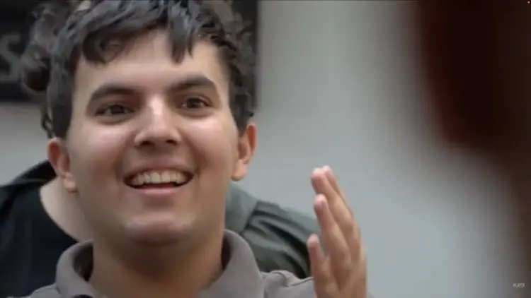 Autistic teenager smiling and interacting during Flute Theatre’s Hunter Heartbeat Method workshop, using theatre games to build communication and connection.